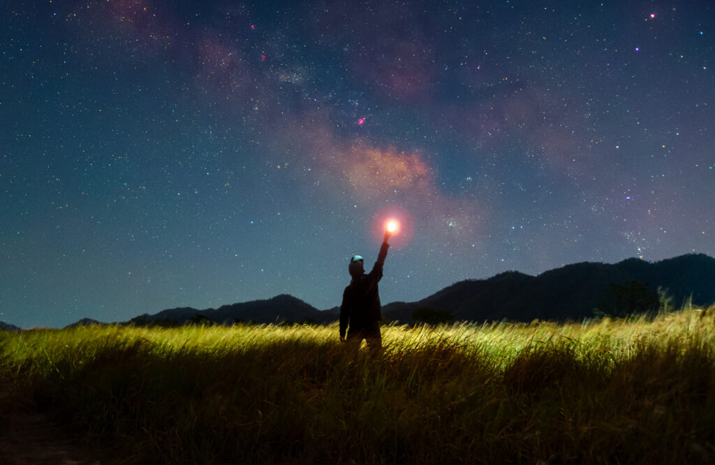 Man in field at night - alien abduction insurance